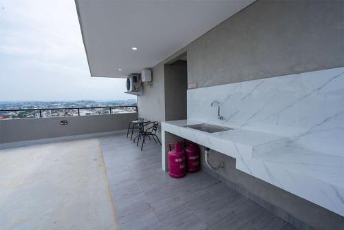 a kitchen with a sink and a counter with pink boots at Trifena Residence in Kalibanteng-lor