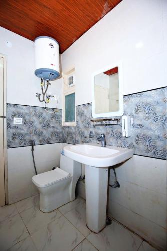 a bathroom with a sink and a toilet at Decent Stays Rooms and Apartments in Shimla