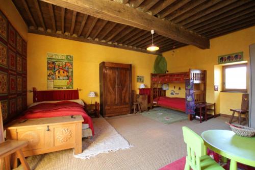 a bedroom with a bed and a table in a room at Maison poumarou in Sainte-Colome