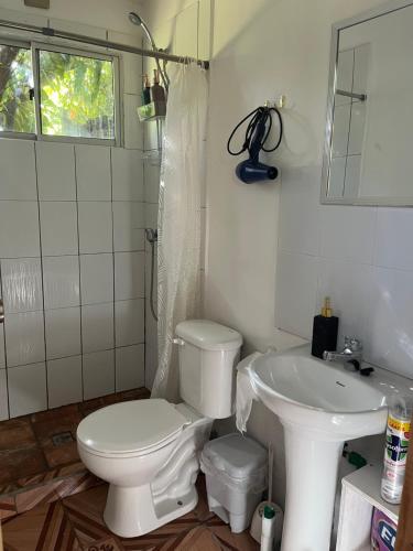 a bathroom with a toilet and a sink at Cabaña Rei miro in Hanga Roa