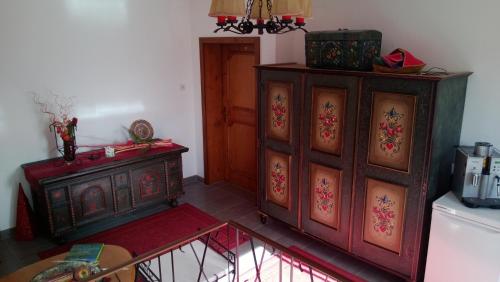 a room with two wooden cabinets and a table at Ferienhaus Burgblick in Treffen
