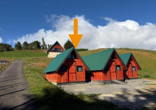 a group of cabins sitting on top of a hill at Cabaña Joy-C Colibri 1 in El Copey