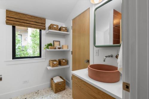 a bathroom with a vessel sink and a window at Newly Remodeled Bayview Cabin 6! in Traverse City