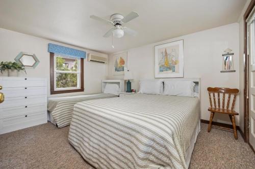 a bedroom with two beds and a ceiling fan at Topico Cabin 5 . Topico Cabin 5 in Traverse City