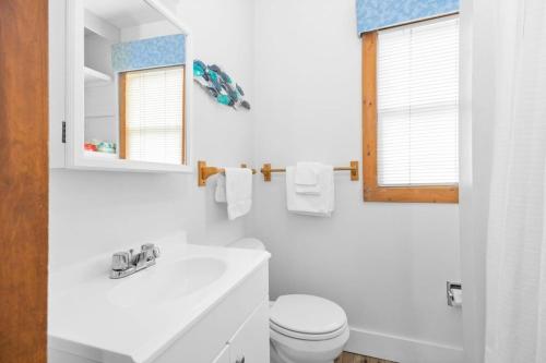 a white bathroom with a sink and a toilet at Topico Cabin 5 . Topico Cabin 5 in Traverse City