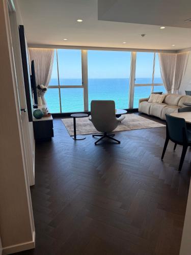 a living room with a view of the ocean at Golden Sands on the Beach - Absolute Beachfront Apartments in Gold Coast