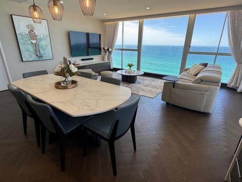 a living room with a table and a couch at Golden Sands on the Beach - Absolute Beachfront Apartments in Gold Coast