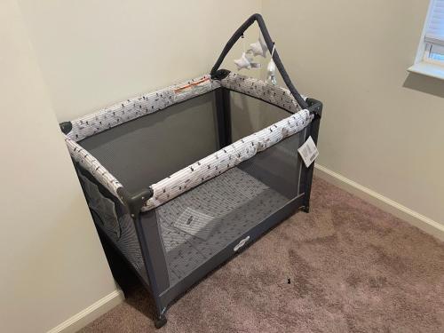 an empty baby crib in a corner of a room at Inner Haven Family Homes in Indianapolis