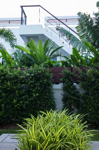 a building with a bunch of plants and a staircase at Luxury House in Hua Hin in Khao Tao
