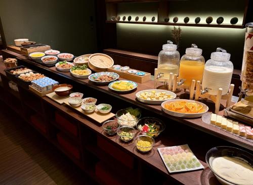 a buffet line with many different types of food at HOTEL AMANEK Kanazawa in Kanazawa