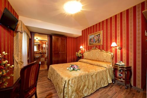 
a hotel room with a large bed and a large window at Hotel Città Di Milano in Venice
