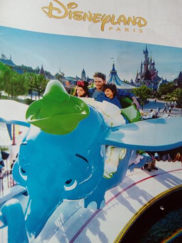 a group of children riding on a ride at the disneyland park at Gîtelabaronnaise avec piscine chauffée prés parc Asterix in Baron