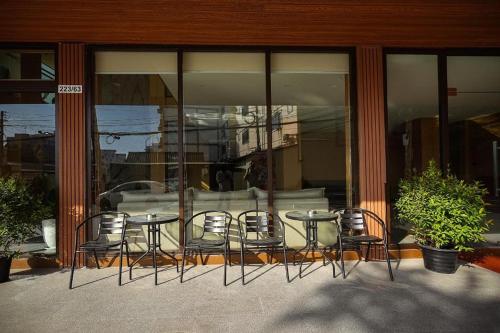 a group of chairs and tables in front of a building at VELIN Pattaya Hotel in Pattaya