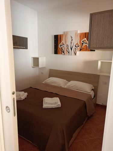 a bedroom with a bed with two towels on it at Fabian Appartament in Bagheria