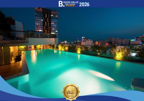 a swimming pool on top of a building at night at Alagon Saigon Hotel & Spa in Ho Chi Minh City