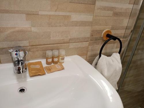 a bathroom sink with two bottles of essential oils on it at Fabian Appartament in Bagheria