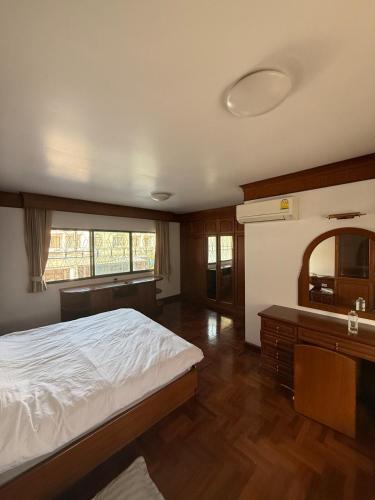 a bedroom with a bed and a sink and a mirror at 5BR Private Pool in Jomtien Beach
