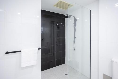 a shower with a glass door in a bathroom at Bay View Alfresco in Lorne