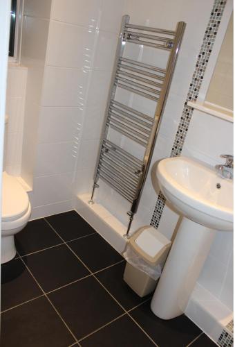 a bathroom with a toilet and a sink at The Premier Lodge in Morpeth