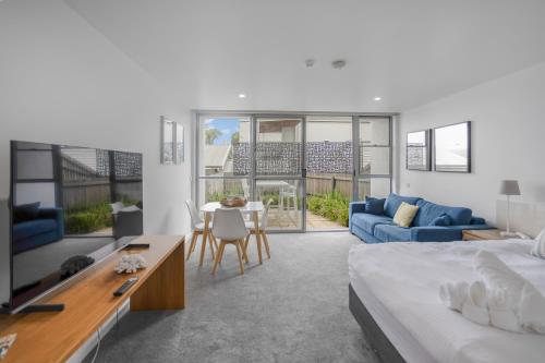 a bedroom with a bed and a living room at Bay View Alfresco in Lorne