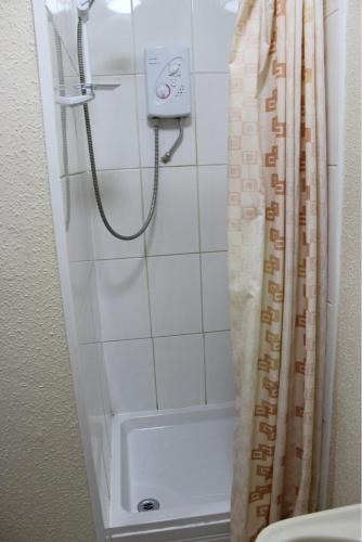 a bathroom with a shower and a sink at The Premier Lodge in Morpeth