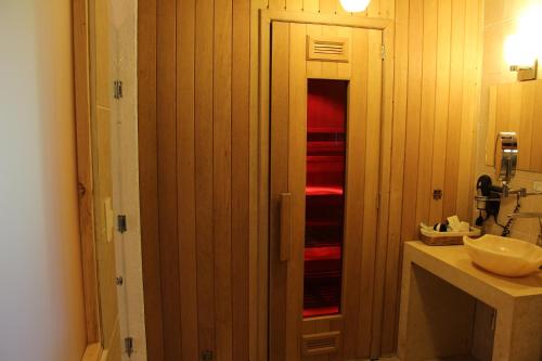 a bathroom with a sink and a door to a bathroom at La Capilla Hotel Boutique in Valle de Bravo
