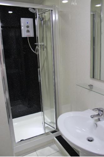 a bathroom with a shower and a sink at The Premier Lodge in Morpeth
