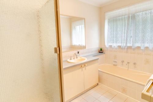 a bathroom with a sink and a tub and a shower at Hargreaves House in Bright