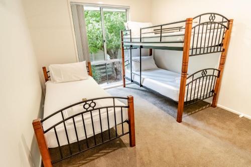 a bedroom with two bunk beds and a window at Hargreaves House in Bright