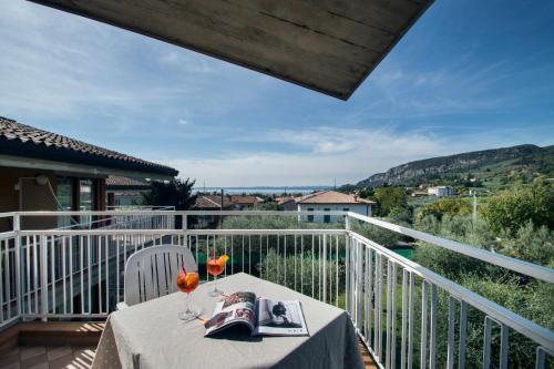 a table on the balcony of a house at Residence Villa Rosa in Garda