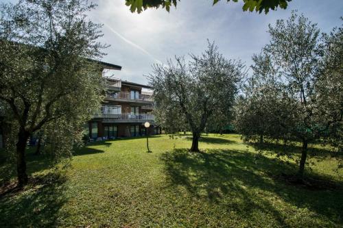 an apartment complex with trees in front of a building at Residence Villa Rosa in Garda