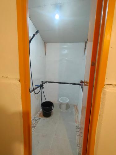a small bathroom with a toilet in a room at Beatus Residence San Isidro in New Agutaya