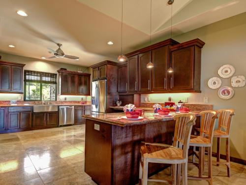a kitchen with wooden cabinets and a large island at Mahana House Country Inn in North Hilo