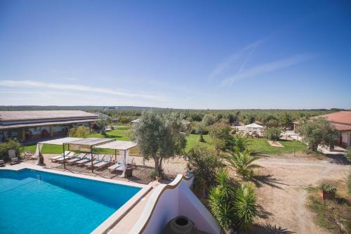 an aerial view of a house with a swimming pool at Monte Chalaça - Turismo Rural in Ferreira do Alentejo