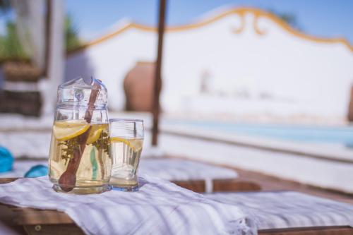 a glass jar of liquid sitting on top of a table at Monte Chalaça - Turismo Rural in Ferreira do Alentejo