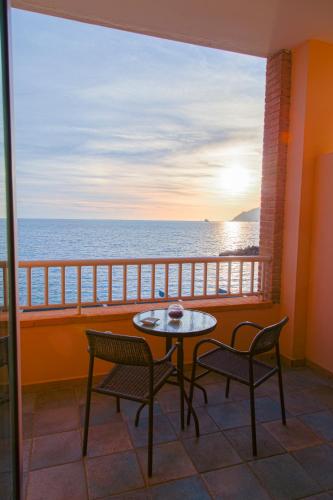 a balcony with a table and chairs and the ocean at Hotel Centro Congressi Polo Nautico in Salerno