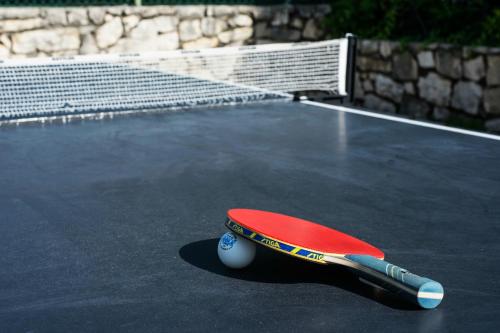 a tennis racket sitting on top of a tennis court at Residence Villa Rosa in Garda