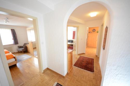 a hallway with an archway leading to a living room at Chesa Talvo, Samedan in Samedan
