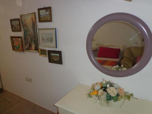 a room with a mirror and a table with flowers at Agriturismo Sorgente di Luna in Larino