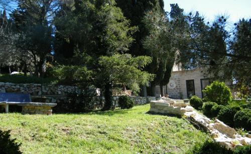 a yard with a stone wall and a house at Agriturismo Sorgente di Luna in Larino