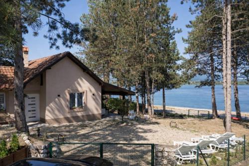 a house with a view of the water at Borova Bajka - Peace & Privacy by the Danube in Usije