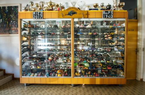 a display cabinet filled with toy action figures at Residence Villa Rosa in Garda