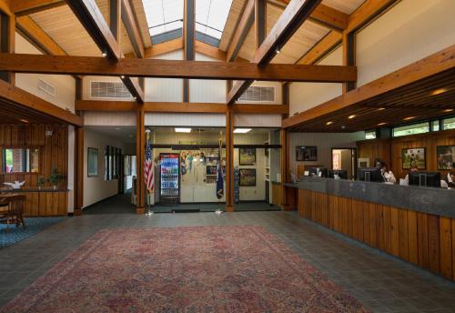 a lobby of a building with wooden beams at Williamsburg Woodlands Hotel & Suites, an official Colonial Williamsburg Hotel in Williamsburg