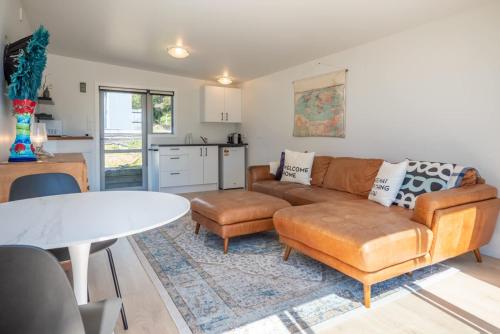 a living room with a couch and a table at Pohara's Beachside Gem in Pohara