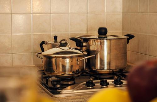 a pots and pans sitting on top of a stove at Residence Villa Rosa in Garda