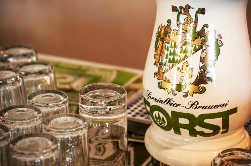 a bottle of water sitting on a table with glasses at Residence Villa Rosa in Garda