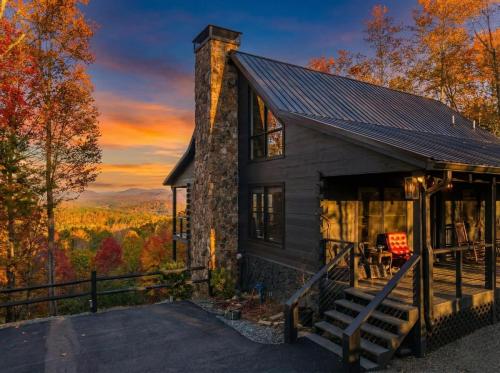 a cabin in the woods with a sunset at Top of the Mountain Breathtaking Views Hot Tub in Blue Ridge
