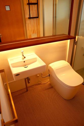 a bathroom with a sink and a toilet at Hummocks in Sesoko