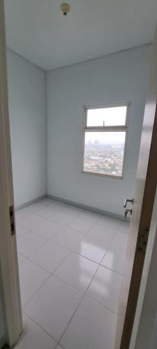 an empty room with a window and a white floor at Apartement ayodhya 2BR Unfurnished in Tjikokol