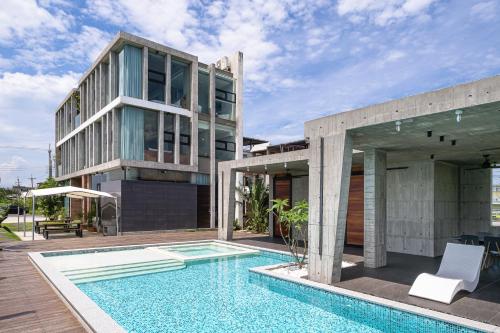 a house with a swimming pool next to a building at 135 會館 135 Private Villa Yilan in Dongshan